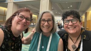 Dee Sparacio at the 2023 SGO Annual Meeting on Women's Cancer with two members of her initial ovarian cancer treatment team, Allison Wagreich, MD (left) and Lorna Rodriguez-Rodriguez, MD, PhD (right)